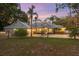 House exterior at dusk showcasing landscaping and a metal roof at 13041 Se 158Th Ln, Weirsdale, FL 32195