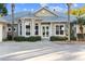 Front entrance features double doors and lush landscaping at 13041 Se 158Th Ln, Weirsdale, FL 32195