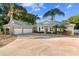 House exterior with metal roof and 3-car garage at 13041 Se 158Th Ln, Weirsdale, FL 32195