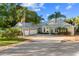 House exterior with circular driveway and palm trees at 13041 Se 158Th Ln, Weirsdale, FL 32195