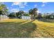 Detached three-car garage with open grassy area at 13041 Se 158Th Ln, Weirsdale, FL 32195