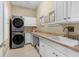 Laundry room with stacked washer and dryer, and ample counter space at 13041 Se 158Th Ln, Weirsdale, FL 32195