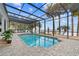 Relaxing screened pool and patio overlooking the lake at 13041 Se 158Th Ln, Weirsdale, FL 32195