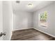 Bright bedroom with wood-look floors and a large window at 13183 Sw 113Th Place, Dunnellon, FL 34432