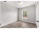 Bright bedroom with wood-look floors and a large window at 13183 Sw 113Th Place, Dunnellon, FL 34432