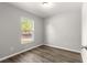 Bright bedroom with wood-look floors and a large window at 13183 Sw 113Th Place, Dunnellon, FL 34432