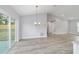 Open concept dining area with light gray walls and wood-look flooring at 14175 Sw 30Th Street Rd, Ocala, FL 34481