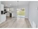 Bright dining room features light gray walls, wood-look flooring, and sliding glass doors leading to the backyard at 14175 Sw 30Th Street Rd, Ocala, FL 34481