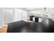 L-shaped kitchen with black countertops and white cabinets at 14221 Ne 47Th Ave, Anthony, FL 32617