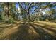 Large grassy yard with mature oak trees at 14221 Ne 47Th Ave, Anthony, FL 32617