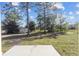 Large backyard with a patio and trees at 15002 Sw 27 St, Ocala, FL 34481