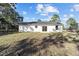 View of a bright white house with a well-manicured lawn and sliding glass door at 15002 Sw 27 St, Ocala, FL 34481