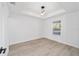 Bright bedroom featuring wood-look floors, a modern light fixture and a window at 15002 Sw 27 St, Ocala, FL 34481