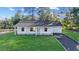 Newly constructed home with a white exterior, gray roof, and a paved driveway at 15002 Sw 27 St, Ocala, FL 34481