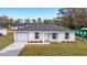 Newly built home with a gray roof and a front yard at 15498 Sw 8 Pl, Ocala, FL 34481