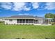 Back exterior view of house with large screened porch at 17380 Se 98Th Cir, Summerfield, FL 34491