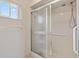 Bathroom with shower stall and grab bars for accessibility at 17890 Se 96Th Ct, Summerfield, FL 34491