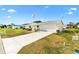 Front view of a house with a driveway and American flag at 17890 Se 96Th Ct, Summerfield, FL 34491