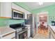 Bright kitchen features stainless steel appliances and a view into the dining area at 17890 Se 96Th Ct, Summerfield, FL 34491