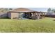 Large backyard with grassy area and wooden fence at 20 Fir Dr, Ocala, FL 34472