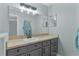 Modern bathroom with gray vanity and a large mirror at 20 Fir Dr, Ocala, FL 34472