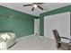 Green bedroom with a ceiling fan and built-in closet at 20 Fir Dr, Ocala, FL 34472