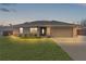 Single story home with gray siding and a two-car garage at 20 Fir Dr, Ocala, FL 34472