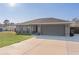 Single story home with gray siding and a two-car garage at 20 Fir Dr, Ocala, FL 34472