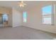 Spacious bedroom with ceiling fan and large windows at 2045 Nw 56Th Ter, Ocala, FL 34482