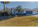 One-story home with gray exterior, palm trees, and a screened porch at 2045 Nw 56Th Ter, Ocala, FL 34482