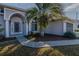 Front entry with arched entryway, and a gray door at 2045 Nw 56Th Ter, Ocala, FL 34482