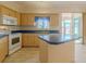 Kitchen with light wood cabinets, blue countertops, and island at 2045 Nw 56Th Ter, Ocala, FL 34482