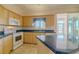 Kitchen with light wood cabinets, blue countertops, and island at 2045 Nw 56Th Ter, Ocala, FL 34482