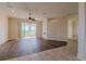 Spacious living room with wood-look flooring and access to a sunroom at 2045 Nw 56Th Ter, Ocala, FL 34482