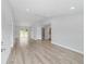 Spacious living room featuring light gray walls and wood-look flooring at 2160 Sw 141 St, Ocala, FL 34481