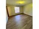 Bright bedroom with wood-look floors and a large window at 2191 Ne 40Th St, Ocala, FL 34482