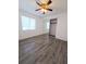 Bright bedroom with wood-look floors and mirrored closet at 2241 Brian Ave, South Daytona, FL 32119