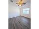 Spacious bedroom with wood-look floors and ceiling fan at 2241 Brian Ave, South Daytona, FL 32119