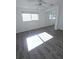 Bright bedroom with wood-look floors and mirrored closet at 2241 Brian Ave, South Daytona, FL 32119