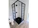 Updated shower with black frame glass doors and marble tile at 2241 Brian Ave, South Daytona, FL 32119