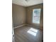 Small empty bedroom features neutral flooring, beige walls, and natural light at 22564 Sw Rainbow Lakes Blvd, Dunnellon, FL 34431