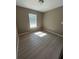 Small empty bedroom features neutral flooring, beige walls, and natural light at 22564 Sw Rainbow Lakes Blvd, Dunnellon, FL 34431