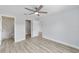 Bedroom with ceiling fan, vinyl flooring, and ensuite bathroom at 2397 Sw 143 Ct, Ocala, FL 34481