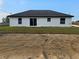 A house backyard featuring sliding glass door and green yard with sandy soil at 262 Locust Rd, Ocala, FL 34472