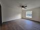 Simple bedroom featuring vinyl floors, a ceiling fan, and a window at 262 Locust Rd, Ocala, FL 34472