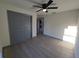 Bright bedroom with ceiling fan and grey sliding doors at 262 Locust Rd, Ocala, FL 34472