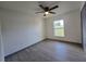 Neutral bedroom with a ceiling fan, window, and vinyl floors at 262 Locust Rd, Ocala, FL 34472