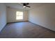 Bright bedroom with ceiling fan and wood-look floors at 262 Locust Rd, Ocala, FL 34472