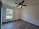 Bedroom featuring hardwood floors, a ceiling fan and natural light from the window view at 262 Locust Rd, Ocala, FL 34472