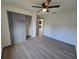 Bedroom with a closet, ceiling fan, and vinyl flooring at 262 Locust Rd, Ocala, FL 34472